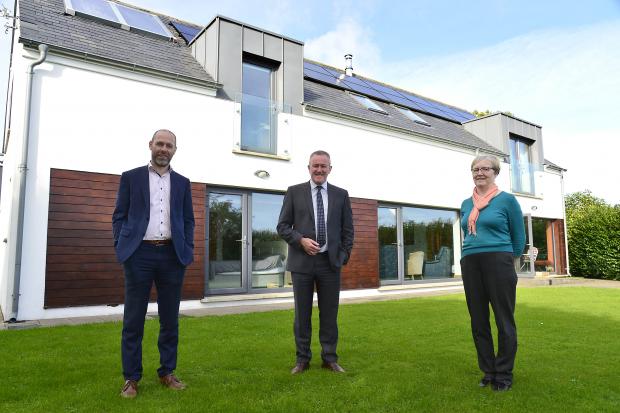 Finance Minister Conor Murphy and others outside passive energy house