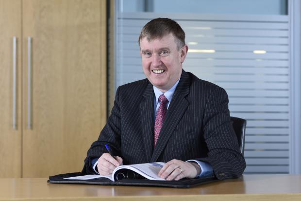 Finance Minister Mervyn Storey at desk