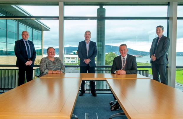 Finance Minister Conor Murphy with company representatives in a boardroom
