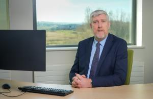 Finance Minister John O'Dowd at his desk