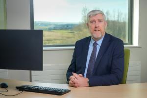 Finance Minister John O'Dowd at his desk